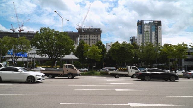 Cars and passing the road by a construction site