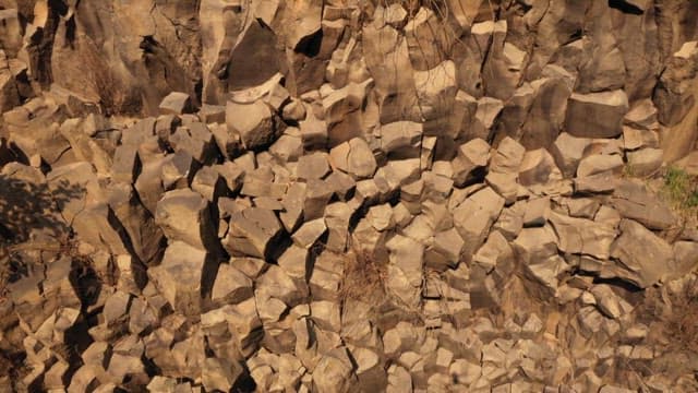 Steep rocky cliff face during a sunny day