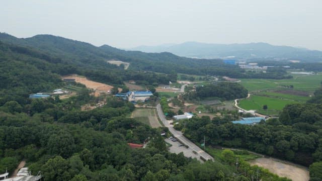 Rural village view with green hills and farmland