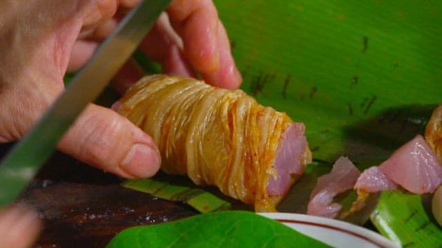 Cutting kimchi tuna rolls with a knife