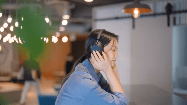 Woman enjoying music with headphones indoors