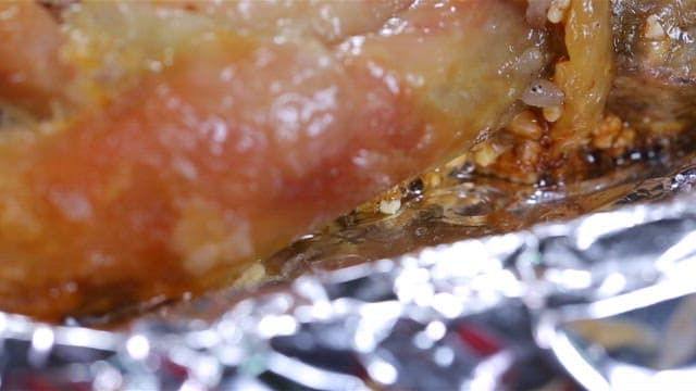 Wood-fired chicken steaming on foil