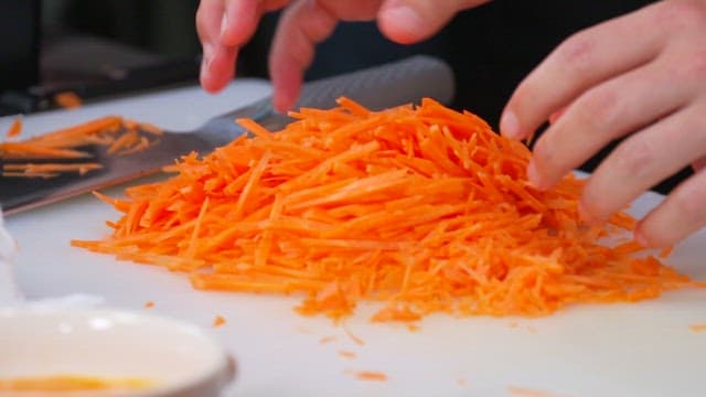 Finely Shredded Carrots on a Cutting Board