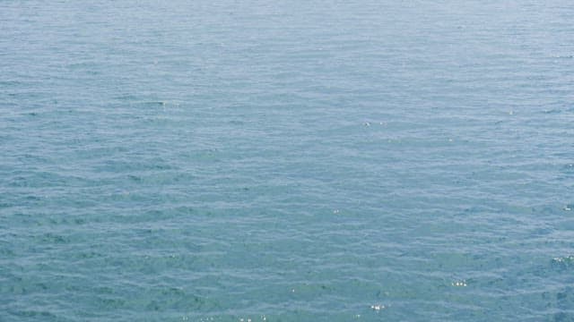 Calm sea with distant mountains