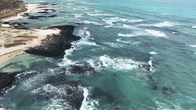 Serene beach with waves and rocks