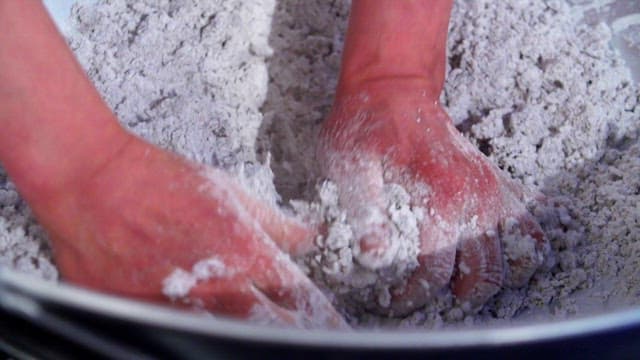 Hand-mixing starch in a large bowl