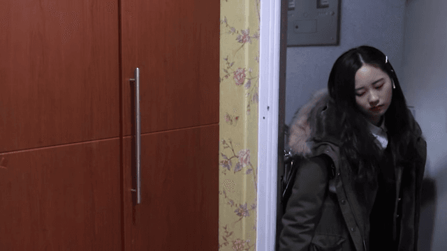 Female student returning home and entering her cozy room