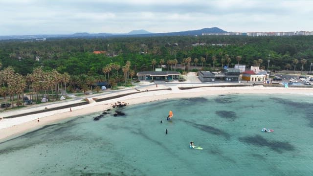 Scenic beach with people enjoying water sports