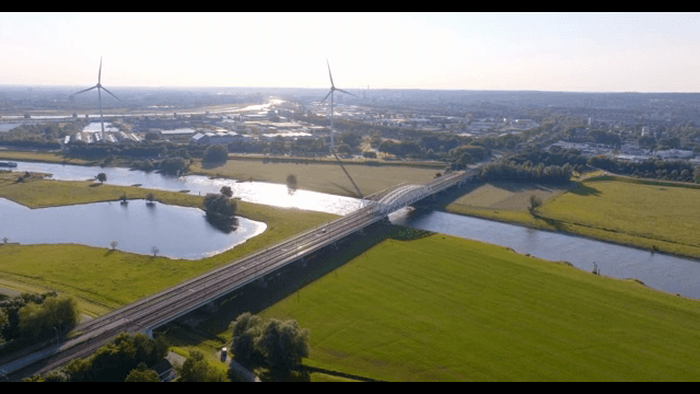 Bridge over a river with wind turbines