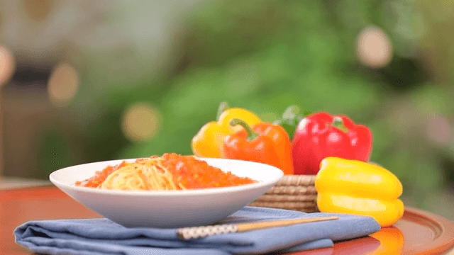 Plate of pasta plated with fresh bell pepper
