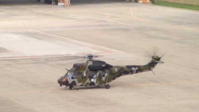 Military helicopter on the airstrip preparing to take off