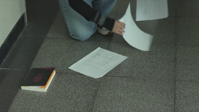 Woman picking up something dropped by friend