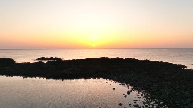 Sunset over a rocky coastline