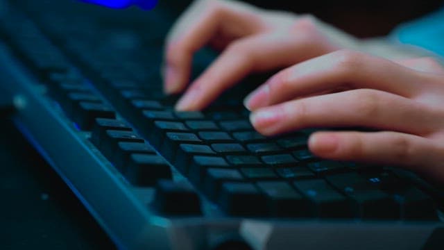 Hands typing on a keyboard
