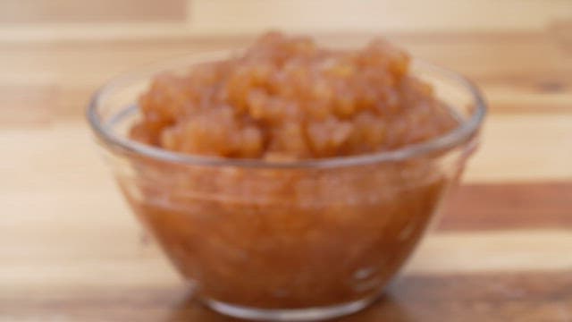 Thick apple jam in a clear glass bowl