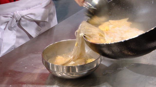 Pouring hot fish cake soup into a bowl