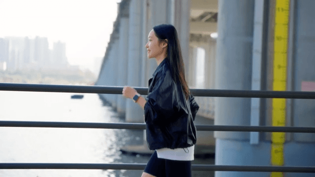 Woman jogging along a riverside path