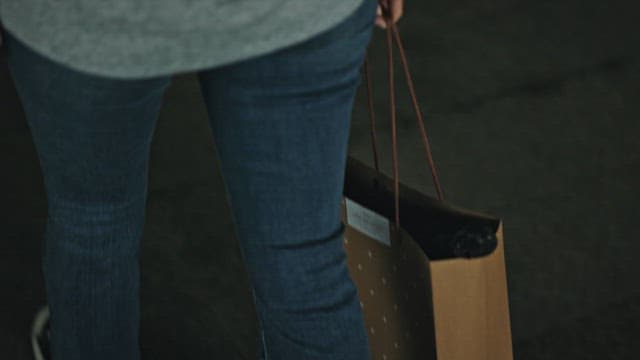Person Walking Through a Dimly Lit Corridor