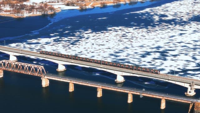 Train Crossing a Frozen River in Winter