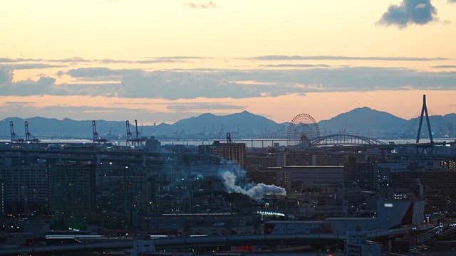 City skyline with ferris wheel at dusk