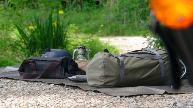 Camping gears set up in a quiet green forest