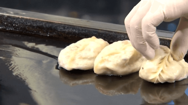 Dumplings frying on a hot griddle