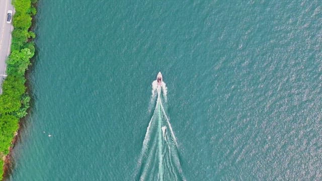 Small boat cruising on a clear blue river
