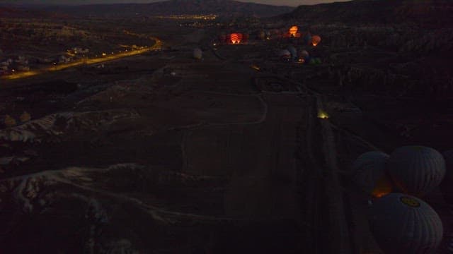 Hot Air Balloons Over Scenic Fields At Dusk