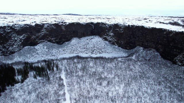 Snow-covered landscape with cliffs