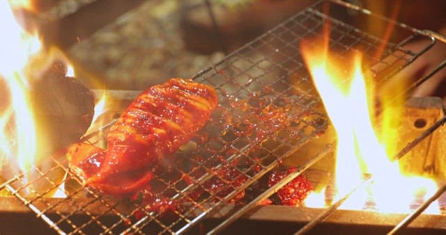 Sizzling squid being cooked on a grill