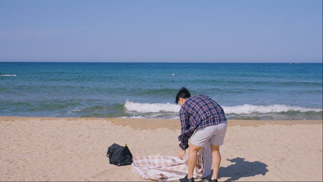 Setting a Mat on the Sandy Beach