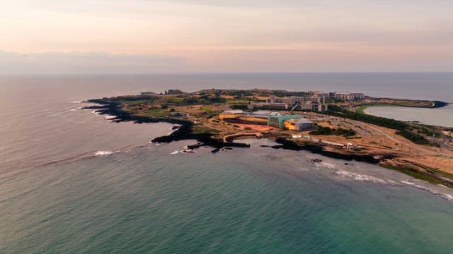 Coastal landscape with buildings at sunset