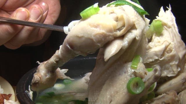 Lifting the chicken leg of a hearty Samgyetang