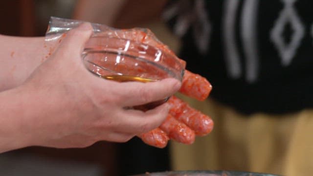 Preparing kimchi with spices and oil in the kitchen
