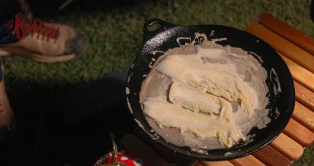 Preparing Vegetable Pancakes Outdoors at Night during Camping
