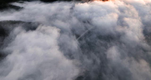 Clouds covering a mountain landscape