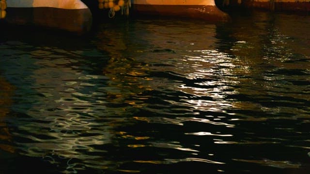 Rolling water surface reflecting a boat