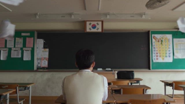 Frustrated Student in a Classroom with Flying Paper