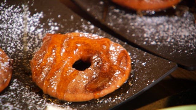 Plate of freshly fried apple with syrup and sugar