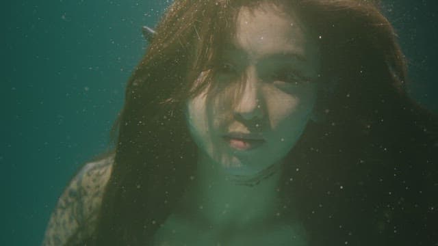 Woman floating underwater with her hair drifting