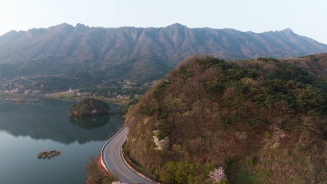 Winding road by a serene mountain lake