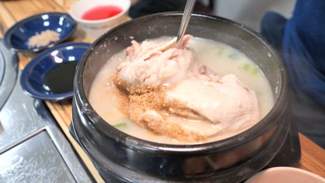 Boiling Samgyetang with Sesame Seeds in Black Pot