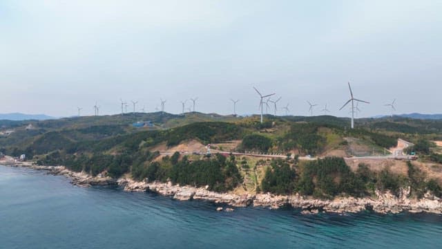 Coastal hills with wind turbines