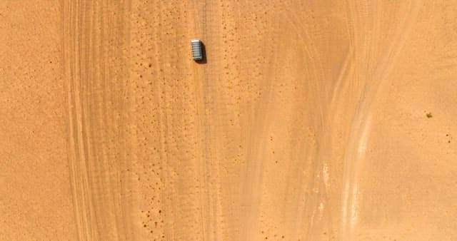 Vehicle traveling through a vast desert