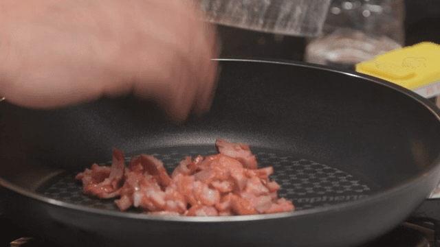 Chopped smoked duck in a heated frying pan