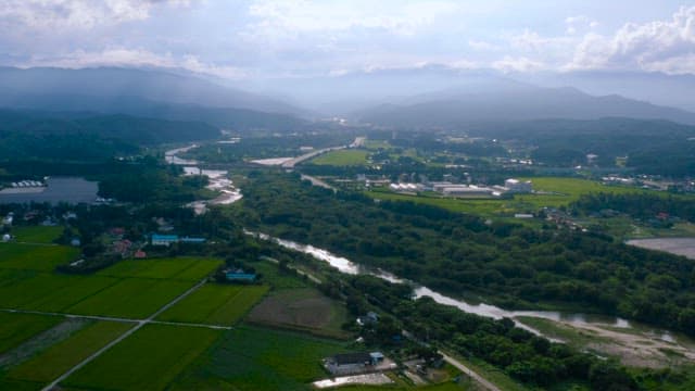 Rural Landscape with a Narrow River Below the Mountain