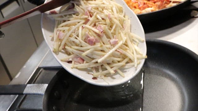 Bacon potato pancake dough in a frying pan