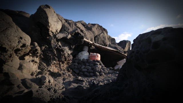 Small cave on the shore with a buoy visible