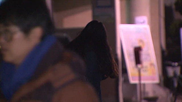 Student Walking Alone in the City at Night