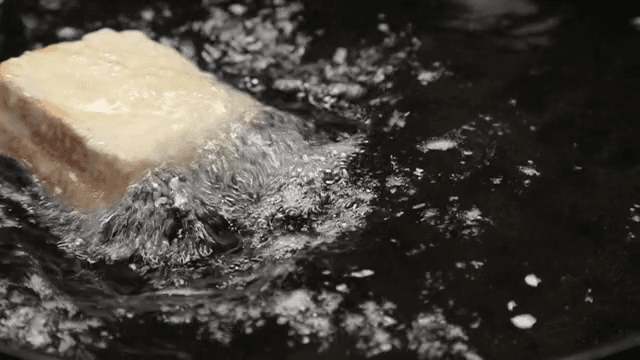 Bread frying in hot oil in a pan